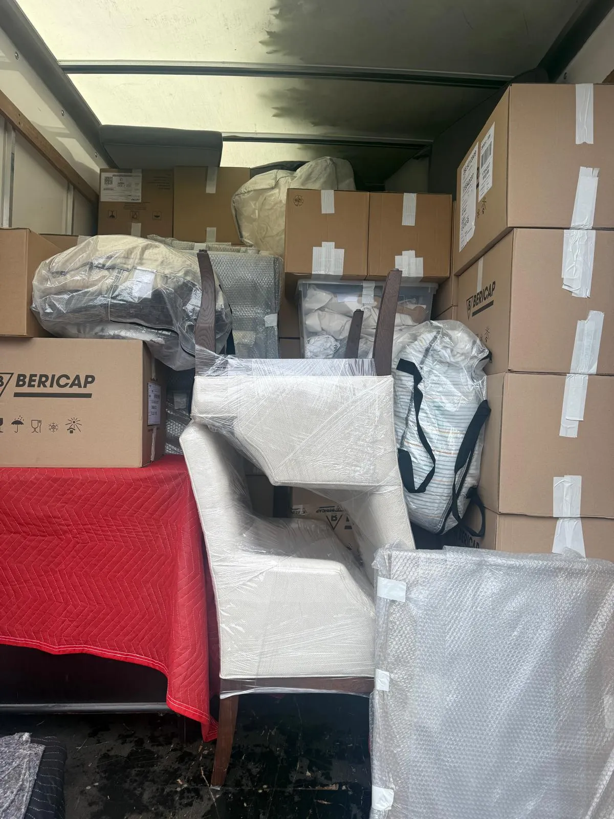 Chairs and boxes packed inside a removal van
